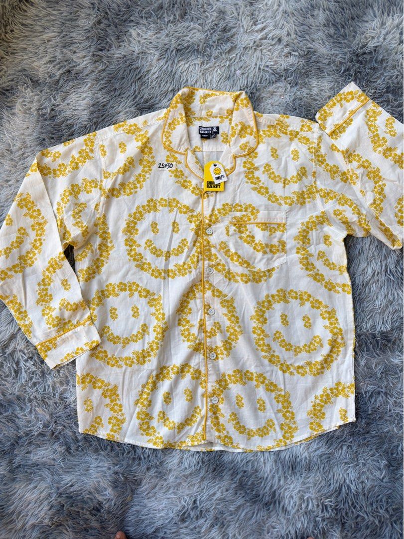 China town Market Smiley (Category: Shirts) located in Legazpi City. Submitted by tiny0509 (Listing ID 1411168389, Image 1). Description: - Chico Market pajama shirt - White with yellow smiley face pattern - Long sleeves - Collared neckline - Button-down front - Chest pocket - Yellow trim oversized -25x30 dimes.