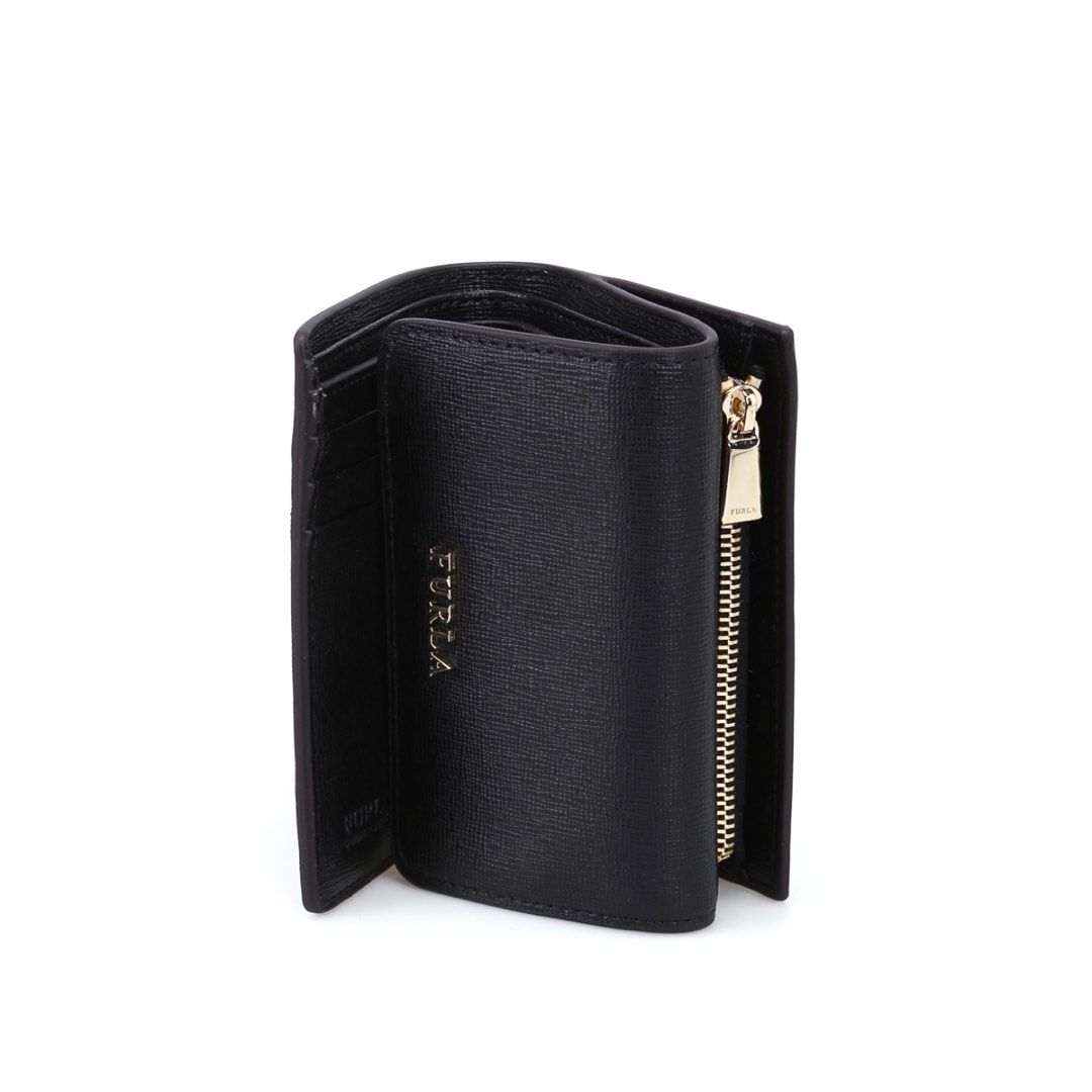 Furla Babylon Trifold Black Leather Wallet (Category: Luxury Bags & Wallets) located in Santa Maria. Submitted by rsr__ (Listing ID 1411196453, Image 2). Description: Authentic Bought from Japan Grade B (good & used condition) Message me for actual pictures :) Black Furla wallet. It features a flap closure with the Furla logo. The wallet opens to reveal multiple card slots and a zippered compartment. The wallet is compact and suitable for everyda