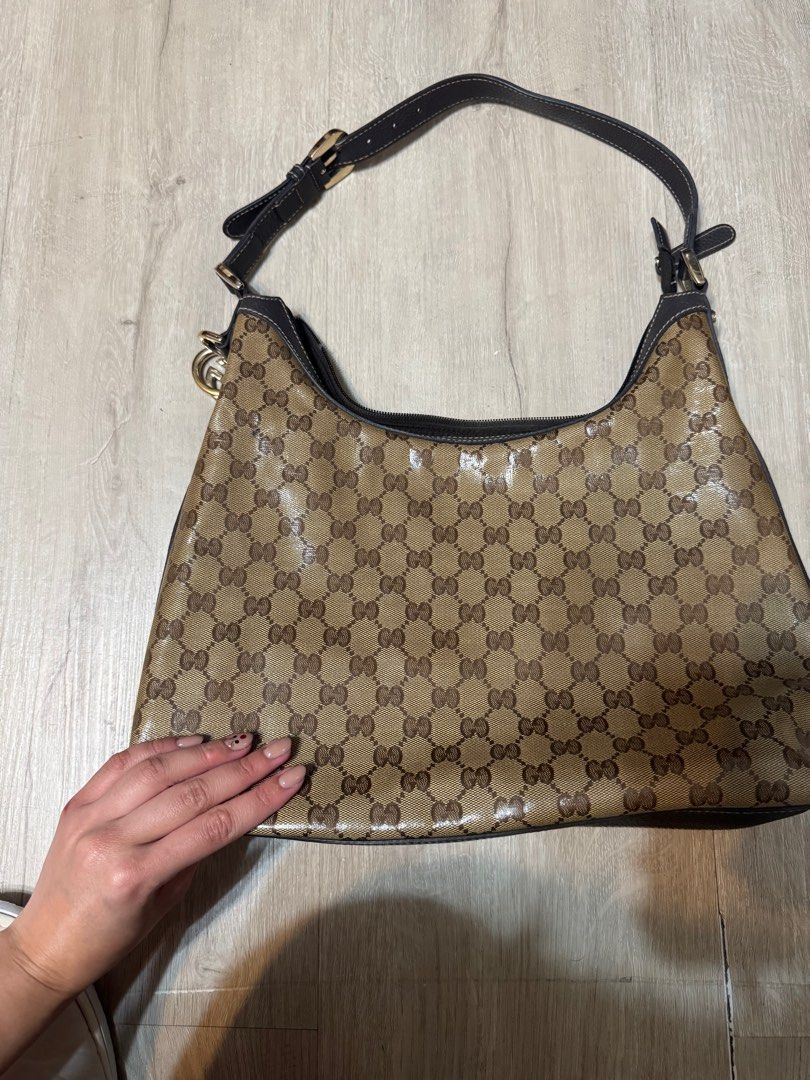 Gucci GG Canvas Hobo Bag (Category: Luxury Bags & Wallets) located in Taguig. Submitted by whitechocolatechip (Listing ID 1411232019, Image 1). Description: - Authentic Gucci hobo bag -Snake leather type - Iconic GG canvas - Brown leather strap and trim - Gold-tone buckle and charm - Brown fabric interior with pocket - NO FLAWS - Includes serial number.