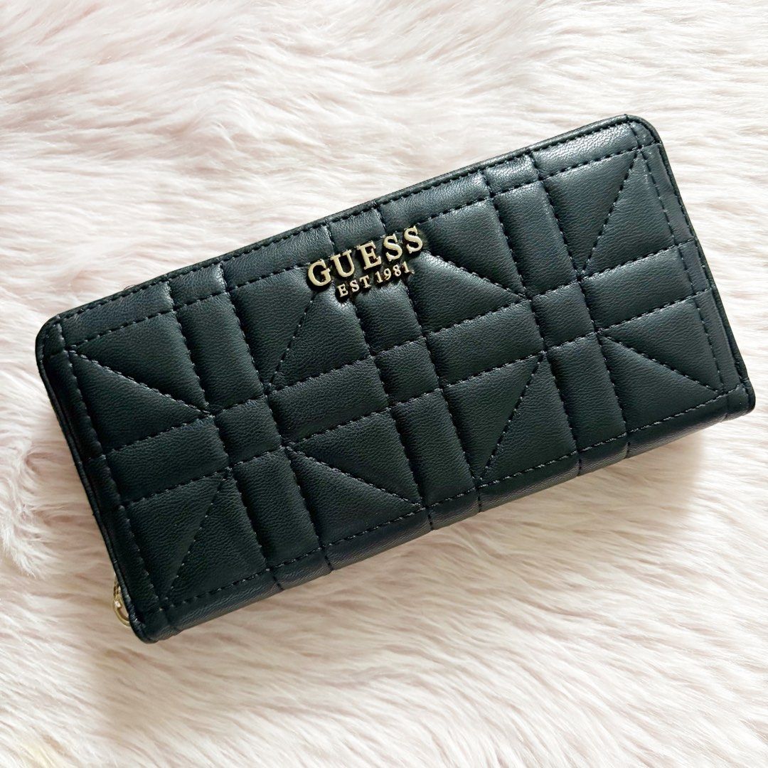 Guess Assia Large Zip-Around Wallet in Black (Category: Wallets & Card holders) located in Caloocan City. Submitted by _yownice (Listing ID 1411221049, Image 1). Description: Guess Assia Large Zip-Around Wallet in Black 100% original, onhand and ready to ship Actual photos and final price posted. Description: Guess Assia Zip Around Large Wallet, quilted faux leather accessory with metal lettering logo and zip around closure. Interior organised wi