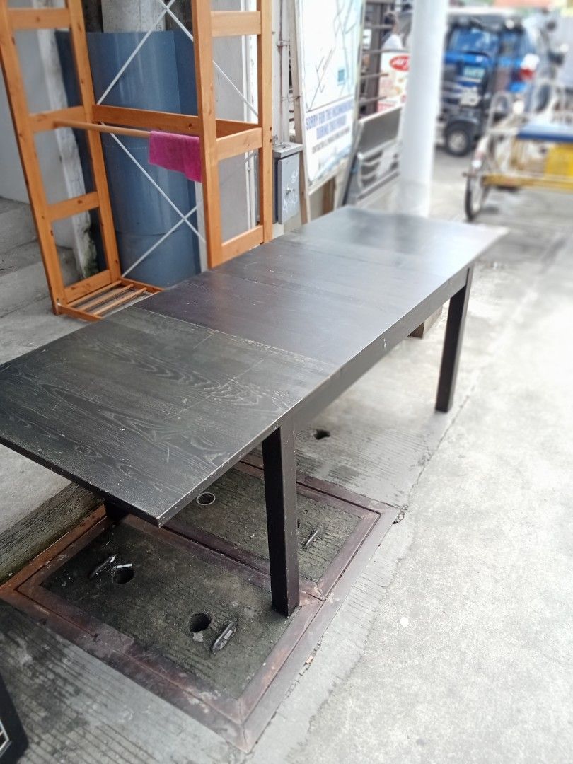 lkea Extendable Dark Wood Dining Table (Category: Tables & Sets) located in Valenzuela. Submitted by kendra071914 (Listing ID 1411187555, Image 1). Description: Extendable dining table features a dark wood finish and a rectangular shape. It has a simple, modern design with four legs. The table can be extended to accommodate more guests. Perfect for family meals or gatherings..