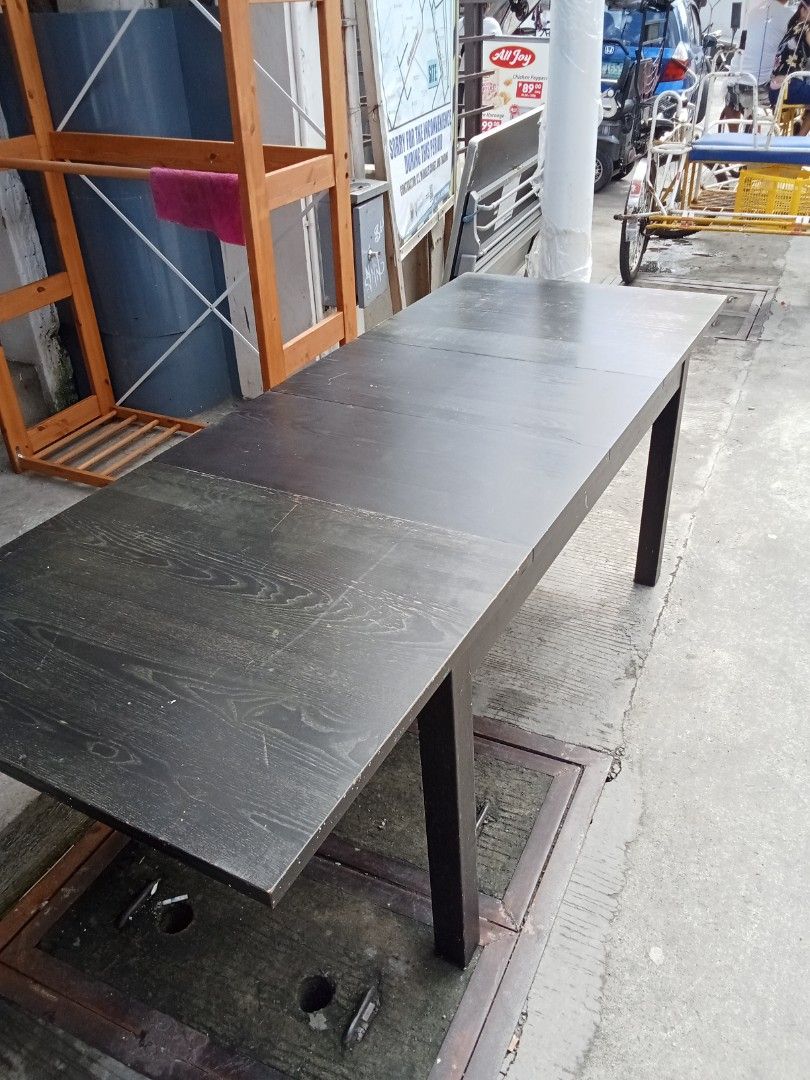 lkea Extendable Dark Wood Dining Table (Category: Tables & Sets) located in Valenzuela. Submitted by kendra071914 (Listing ID 1411187555, Image 3). Description: Extendable dining table features a dark wood finish and a rectangular shape. It has a simple, modern design with four legs. The table can be extended to accommodate more guests. Perfect for family meals or gatherings..