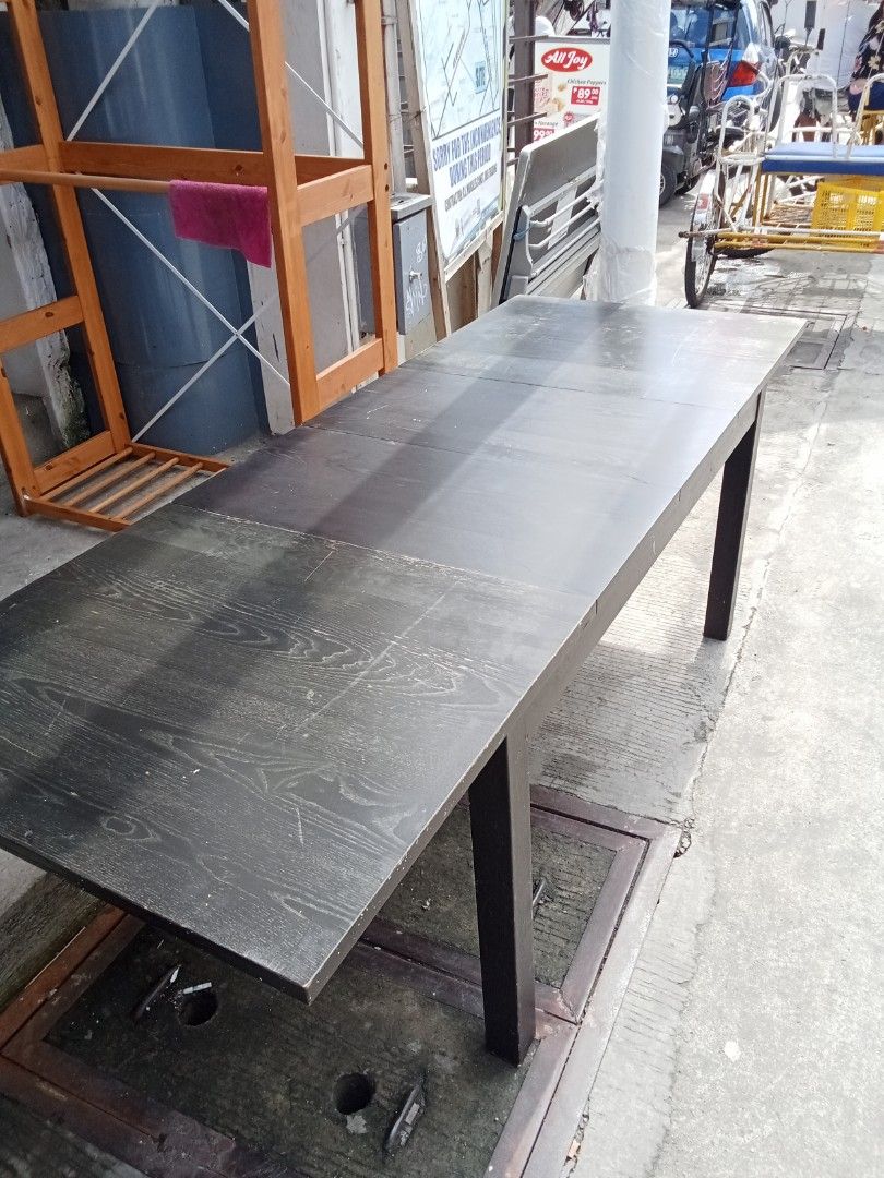 lkea Extendable Dark Wood Dining Table (Category: Tables & Sets) located in Valenzuela. Submitted by kendra071914 (Listing ID 1411187555, Image 2). Description: Extendable dining table features a dark wood finish and a rectangular shape. It has a simple, modern design with four legs. The table can be extended to accommodate more guests. Perfect for family meals or gatherings..