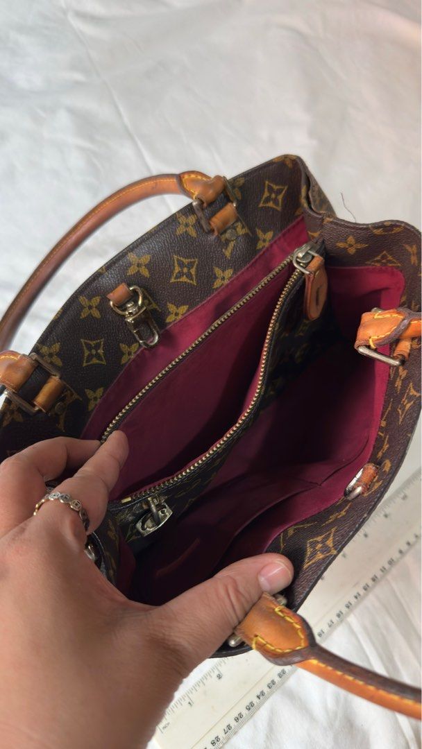 Louis Vuitton Monogram Canvas Bag (Category: Luxury Bags & Wallets) located in Bacoor. Submitted by tisteel56039594 (Listing ID 1411125144, Image 3). Description: LV handbag in classic Monogram canvas. For only Php 1500 ...Features a spacious interior with a zippered pocket and additional compartments. The bag has brown leather handles and trim, with a burgundy interior lining. Includes metal feet on the bottom for protection.. From Korea .