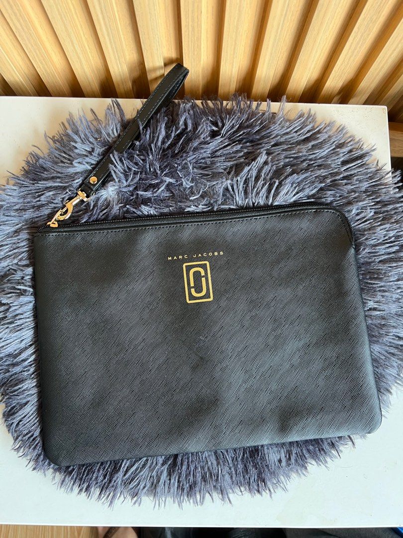 Marc Jacobs Clutch (Category: Luxury Bags & Wallets) located in Lipa City. Submitted by thyra06 (Listing ID 1411209938, Image 1). Description: - Authentic Marc Jacobs clutch - Color: Black - Gold-tone zipper and wrist strap - Marc Jacobs logo on front - Interior pocket with Marc Jacobs tag - Made of textured material.