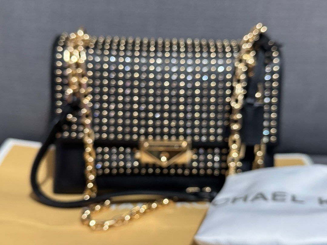 Michael Kors Cece Studded Shoulder sling Bag (Category: Luxury Bags & Wallets) located in Dasmarinas. Submitted by berrylove_preloved (Listing ID 1411187315, Image 2). Description: - Black Michael Kors shoulder bag - Gold-tone hardware and studded detailing - Chain strap - Flap closure with Michael Kors logo - Interior zippered pocket - Includes dust bag.