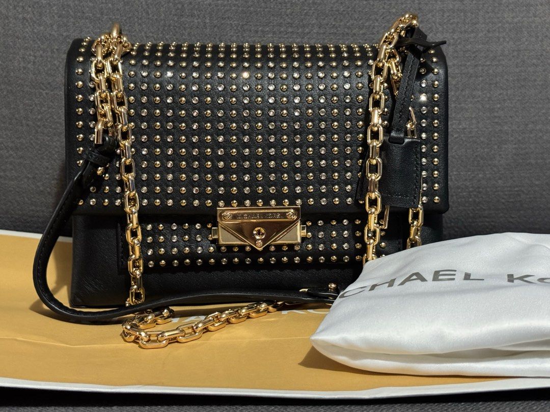 Michael Kors Cece Studded Shoulder sling Bag (Category: Luxury Bags & Wallets) located in Dasmarinas. Submitted by berrylove_preloved (Listing ID 1411187315, Image 3). Description: - Black Michael Kors shoulder bag - Gold-tone hardware and studded detailing - Chain strap - Flap closure with Michael Kors logo - Interior zippered pocket - Includes dust bag.