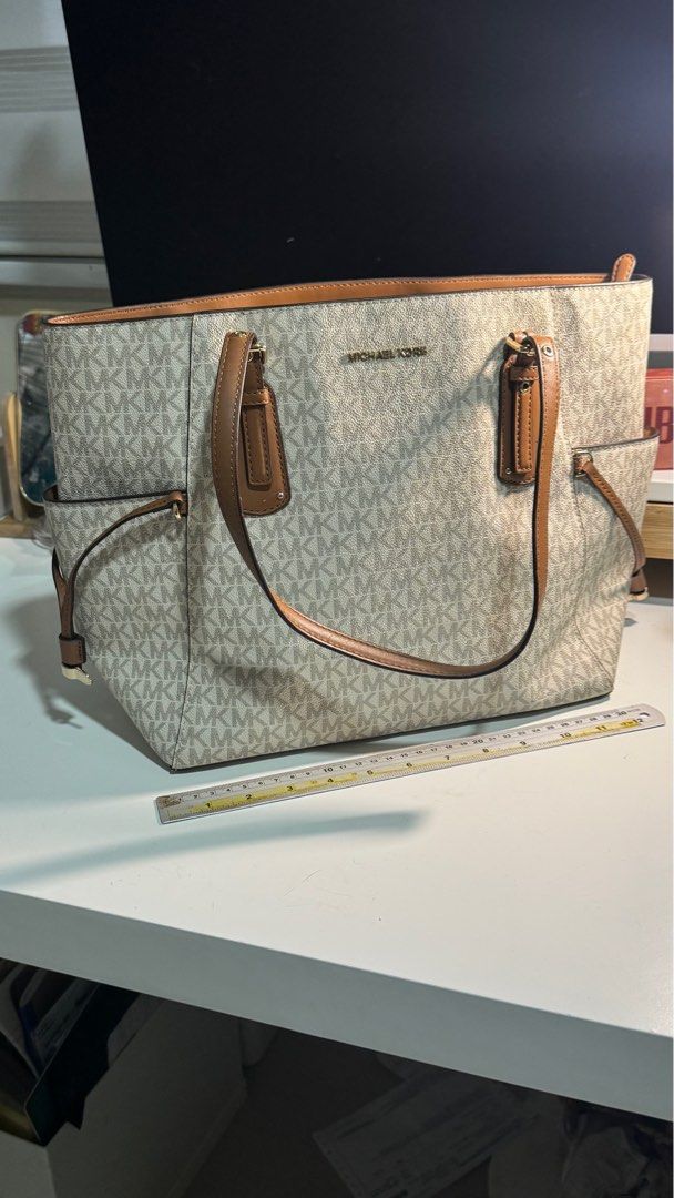 Michael Kors Tote Bag (Category: Luxury Bags & Wallets) located in Manila. Submitted by luxaureph (Listing ID 1411195134, Image 1). Description: Michael Kors Voyager tote bag big enough for laptop Original, bought in the US RFS: rarely used, i have 2 similar MK totes.