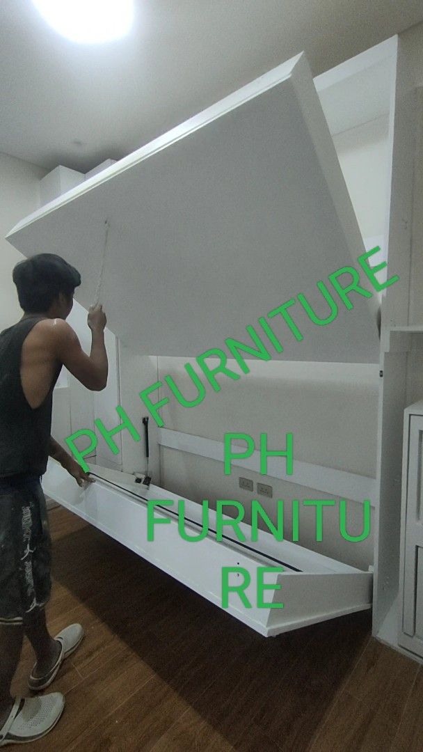 Murphy Bed with Cabinet and table folding chair (Category: Bed Frames & Mattresses) located in Manila. Submitted by jovetph. (Listing ID 1411082620, Image 2). Description: Murphy double deck with integrated cabinet. The bed folds up into the wall, maximizing space. The cabinet provides additional storage. It is a space-saving solution for small rooms or apartments. The bed is shown in different stages of folding and unfolding..