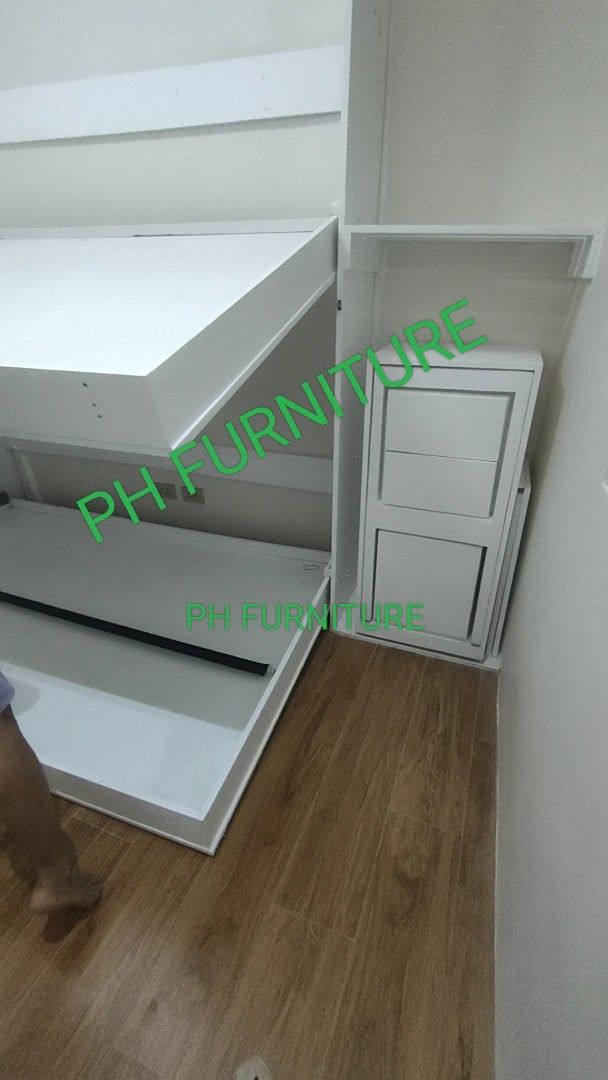 Murphy Bed with Cabinet and table folding chair (Category: Bed Frames & Mattresses) located in Manila. Submitted by jovetph. (Listing ID 1411082620, Image 3). Description: Murphy double deck with integrated cabinet. The bed folds up into the wall, maximizing space. The cabinet provides additional storage. It is a space-saving solution for small rooms or apartments. The bed is shown in different stages of folding and unfolding..