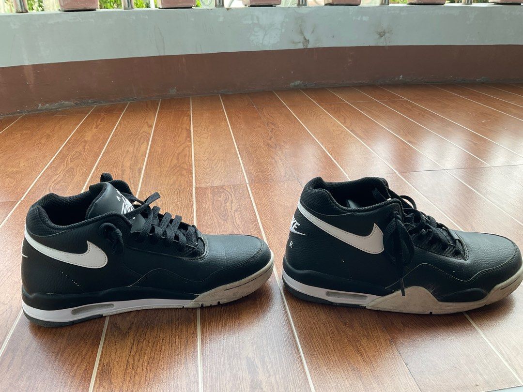 Nike Air Flight High Top Sneakers (Category: Sneakers) located in Tarlac. Submitted by nootactive (Listing ID 1411088832, Image 2). Description: Black and white Nike Air Flight high-top sneakers. Features the Nike Air logo on the back and the Nike swoosh on the sides. The size tag is visible in one of the images. The sneakers have black laces..