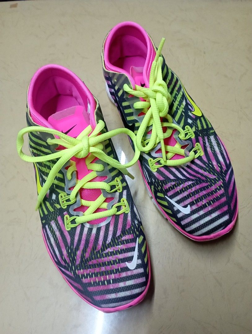Nike Free 5.0 Women's Running Shoes (Category: Sneakers) located in Meycauayan. Submitted by issasvillaflores (Listing ID 1411157803, Image 2). Description: Nike Free 5.0 running shoes for women. Features a vibrant pink, black, and yellow color scheme. The shoes have a flexible sole and a breathable upper. The size is UK 3, EUR 36.5, and US 6. Made in Vietnam..