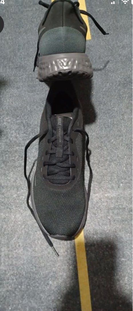 Nike Revolution Black Running Shoes (Category: Sneakers) located in Manila. Submitted by geroasc (Listing ID 1411165897, Image 2). Description: - Black Nike Revolution running shoes - Breathable mesh upper - Secure lace-up closure - Durable rubber sole - Nike logo detail.