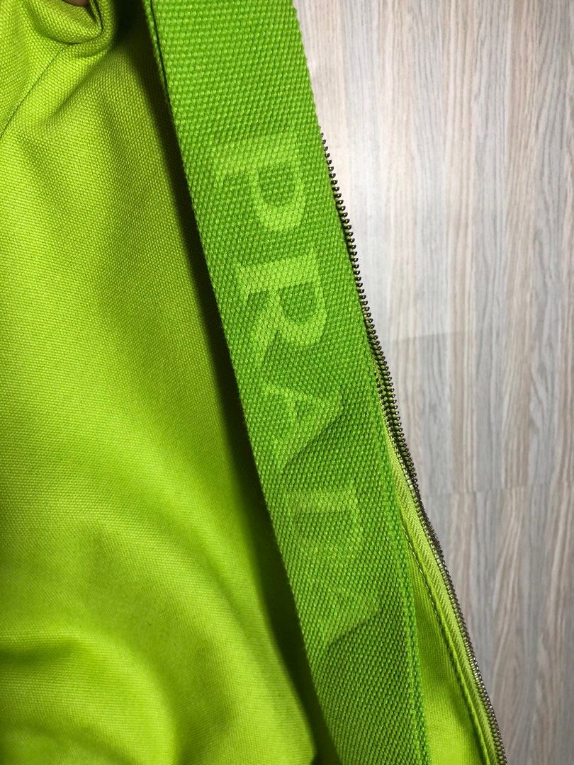 Prada Triangle Shoulder Bag - Green (Category: Luxury Bags & Wallets) located in Montevista. Submitted by rdthriftshub (Listing ID 1411186126, Image 3). Description: Prada shoulder bag in a vibrant green color. Features the iconic Prada triangle logo. The bag has a zip closure and a matching green strap with the Prada logo embossed. The bag's design is a unique triangle shape..