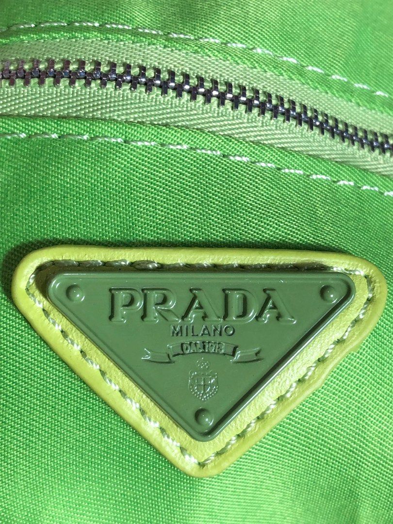 Prada Triangle Shoulder Bag - Green (Category: Luxury Bags & Wallets) located in Montevista. Submitted by rdthriftshub (Listing ID 1411186126, Image 2). Description: Prada shoulder bag in a vibrant green color. Features the iconic Prada triangle logo. The bag has a zip closure and a matching green strap with the Prada logo embossed. The bag's design is a unique triangle shape..