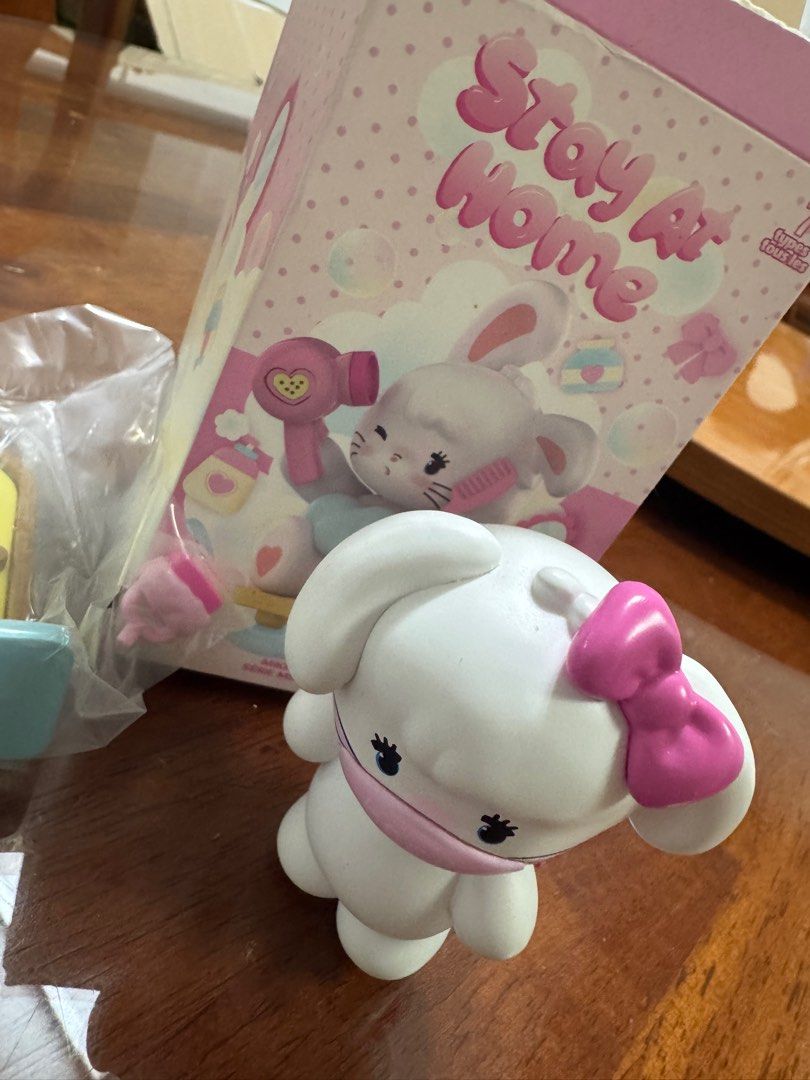 Stay At Home Bunny Figurine (Category: Designer & Blind Box Toys) located in Makati City. Submitted by shopoh (Listing ID 1411205794, Image 1). Description: - Adorable Stay At Home Bunny figurine. - Features a white bunny with a pink bow and face mask. - Box shows a bunny with a hairdryer and other accessories. - Perfect for collectors. - Cute desk decoration..