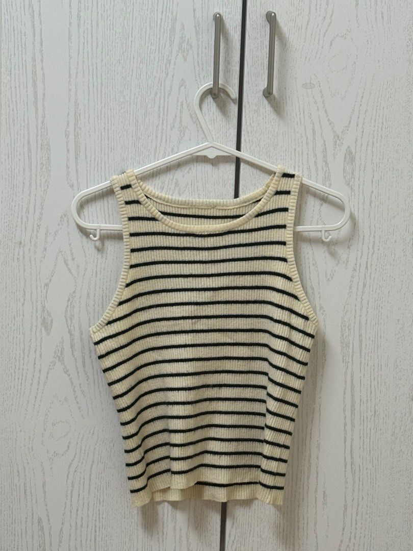 Striped Ribbed Tank Top (Category: Sleeveless) located in Quezon City. Submitted by _cmls (Listing ID 1411219314, Image 1). Description: - Cream and black striped tank top - Cropped length - Ribbed texture - Round neckline - Sleeveless design - Versatile for various outfits.