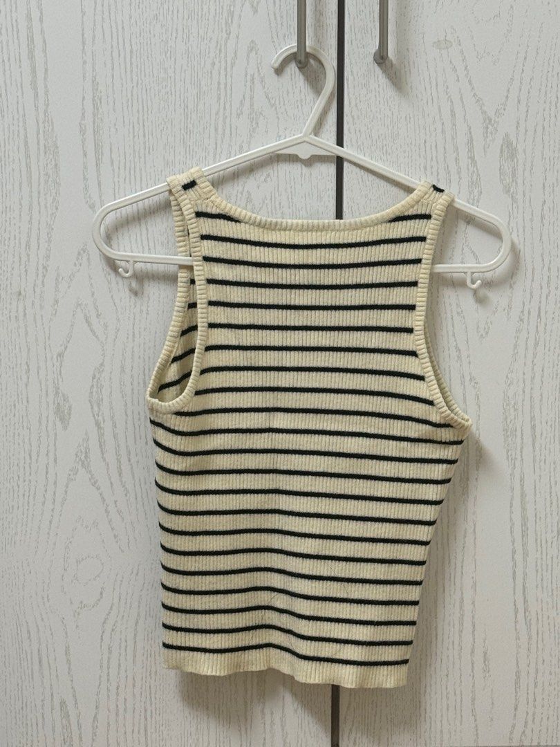 Striped Ribbed Tank Top (Category: Sleeveless) located in Quezon City. Submitted by _cmls (Listing ID 1411219314, Image 2). Description: - Cream and black striped tank top - Cropped length - Ribbed texture - Round neckline - Sleeveless design - Versatile for various outfits.