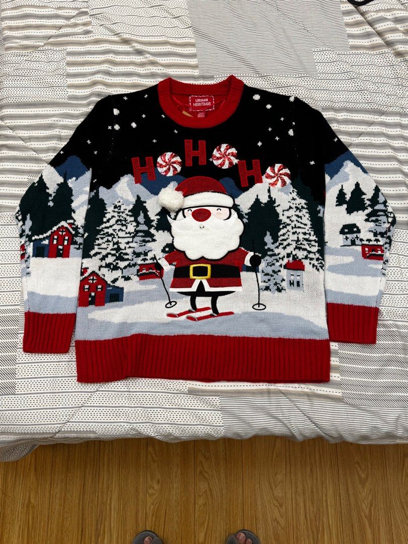 Urban Heritage Christmas Sweater (Category: Coats, Jackets and Outerwear) located in Manila. Submitted by everythinginbetweenbyk (Listing ID 1411124666, Image 1). Description: - Urban Heritage Christmas sweater - Features a skiing Santa Claus design - Black background with white snowflakes - Red accents on collar, cuffs, and hem - Includes images of houses and trees - From Canada 🇨🇦 .