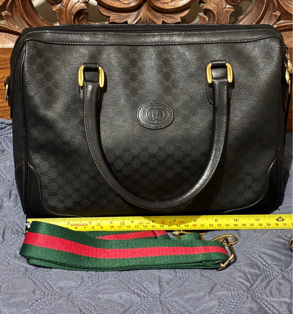 Vintage Gucci Black Micro GG Handbag with Strap (Category: Luxury Bags & Wallets) located in Quezon City. Submitted by exvintagecollector (Listing ID 1411096417, Image 1). Description: - Authentic Gucci handbag -Vintage 70's - Iconic micro GG pattern - Gold-tone hardware - Detachable green and red striped shoulder strap (generic) - Top zipper closure - Single interior zippered pocket - Dark fabric interior lining - Gucci logo on the front no more