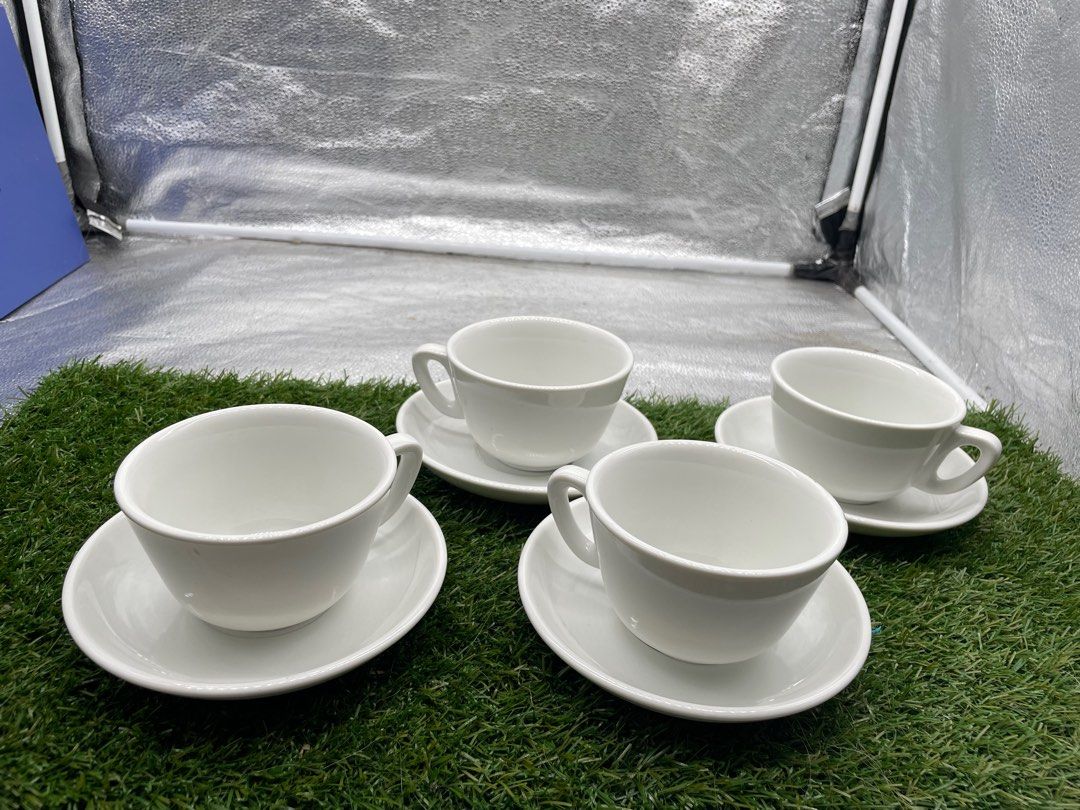 White Tea Cup and Saucer Set (Category: Coffee & Tea Tableware) located in Quezon City. Submitted by eilgaraje (Listing ID 1411244876, Image 1). Description: Set of four white tea cups with matching saucers. The saucers measure approximately 10cm in diameter. The cups appear to be a standard size. Perfect for enjoying tea or coffee. A simple and elegant addition to your kitchen or dining table..