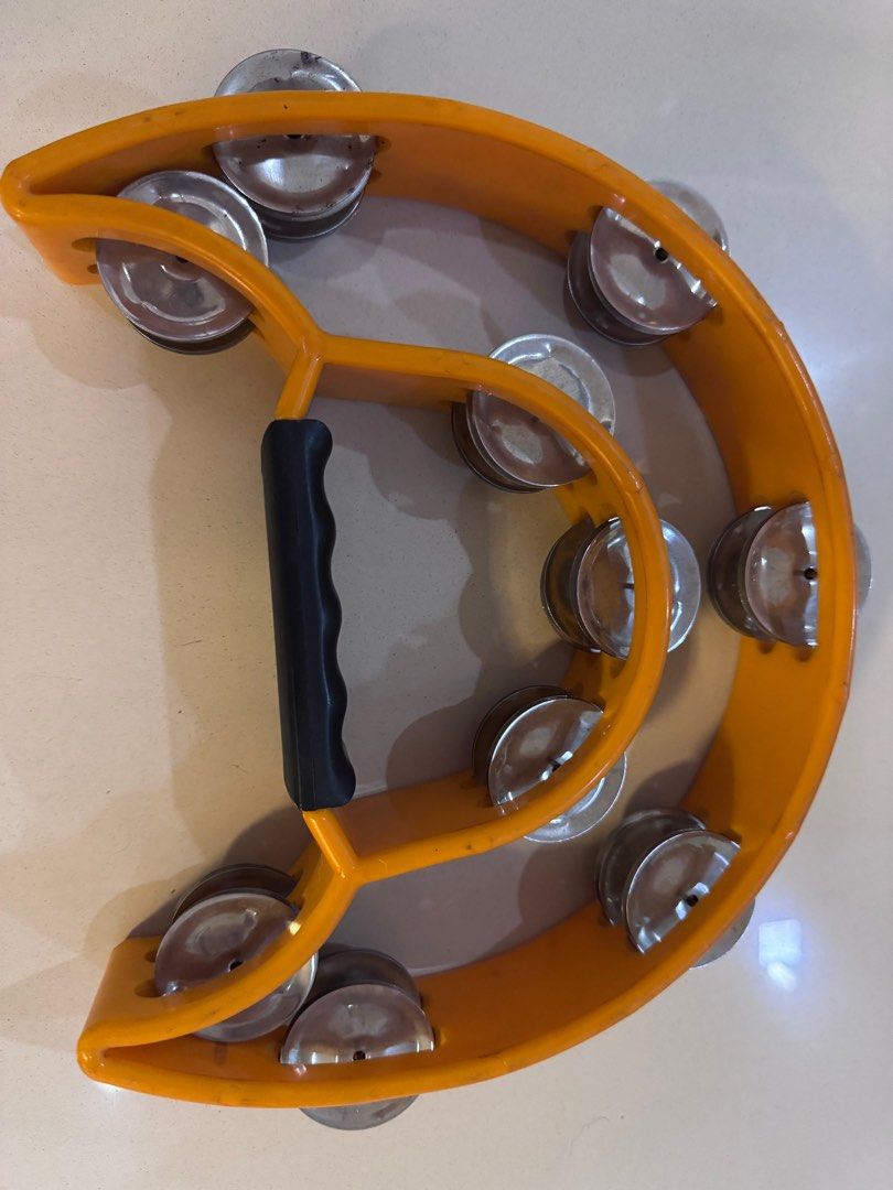 Yellow Tambourine with Handle (Category: Musical Instruments) located in Manila. Submitted by decluterthings888 (Listing ID 1411208087, Image 2). Description: - Bright yellow tambourine - Black handle for easy grip - Equipped with metal jingles - Hand-held design - Suitable for performances or recreational use.