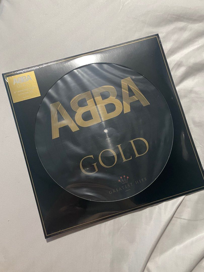 ABBA Gold Greatest Hits Vinyl Record (Category: Vinyls) located in Manila. Submitted by goodboysrecords (Listing ID 1411367060, Image 1). Description: - ABBA Gold Greatest Hits vinyl record. - Features the iconic ABBA gold logo on a black background. - Comes in its original packaging. - Includes a gold sticker. - Album title "Gold" and "Greatest Hits" are clearly visible..