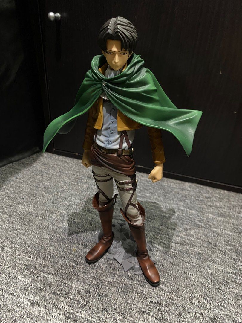 Attack on Titan Levi Figure (Category: Figurines & Statues) located in President Roxas. Submitted by isserminator (Listing ID 1411448014, Image 1). Description: - Levi Ackerman figure from Attack on Titan. - Includes Survey Corps uniform and green cloak. - Detailed facial features and uniform design. - Features a rocky base. - Survey Corps emblem present on the cloak..