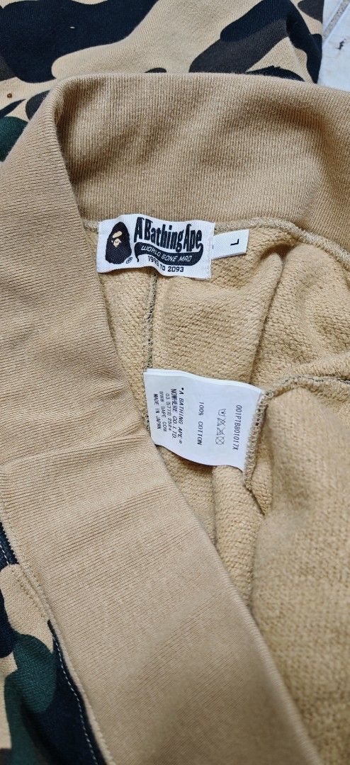BAPE Shark Camo Sweatpants - Size L (Category: Joggers) located in Makati City. Submitted by marquez25 (Listing ID 1411303536, Image 3). Description: - Authentic BAPE sweatpants - Iconic shark face design - Camouflage pattern (yellow, green, black) - Size: L - BAPE logo on tag - Drawstring waistband - Cuffed ankles - Camo pattern on back.