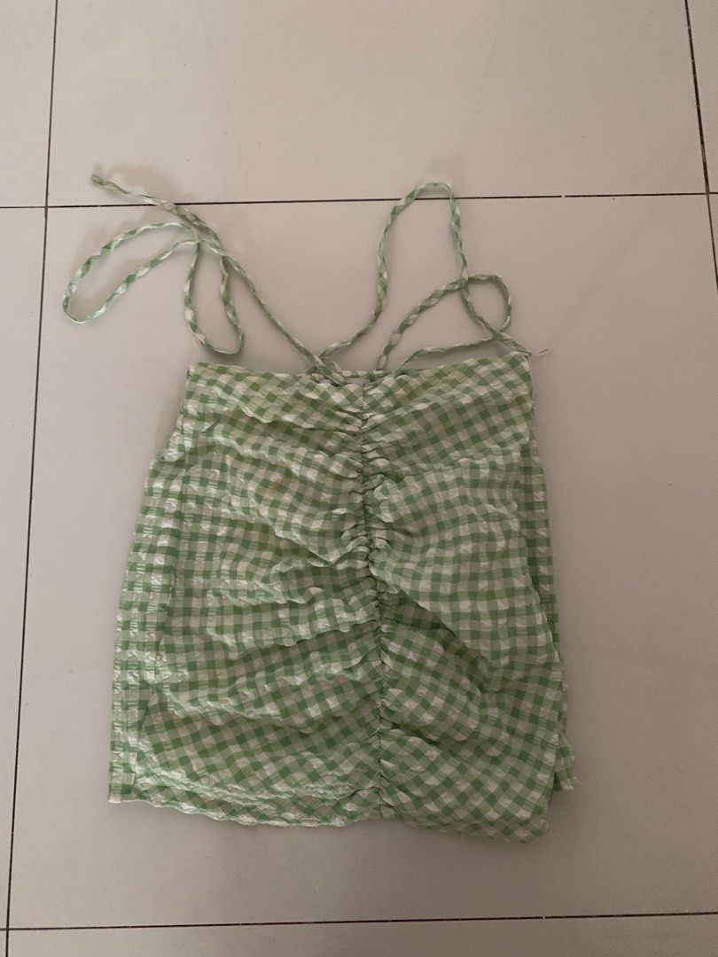 Bershka Skirt (Category: Dresses) located in Pasig City. Submitted by wasabii14 (Listing ID 1411289443, Image 1). Description: - Bershka skirt - Green and white gingham pattern - Size XS - Ruched bodice - Fitted silhouette - Minor stains present - Perfect for casual or summer wear.