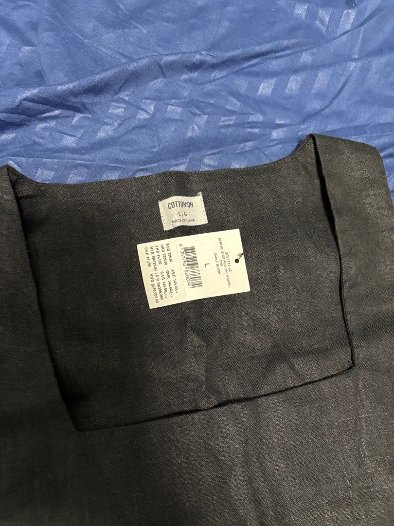 Cotton On Serene Cropped Linen Shell Top - Black (Category: Sleeveless) located in Manila. Submitted by _prelovedbykc (Listing ID 1411397983, Image 2). Description: Cotton On Serene Cropped Linen Shell Top in black. It is a size L. The top has a square neckline. It has a tag attached with the price in different currencies.