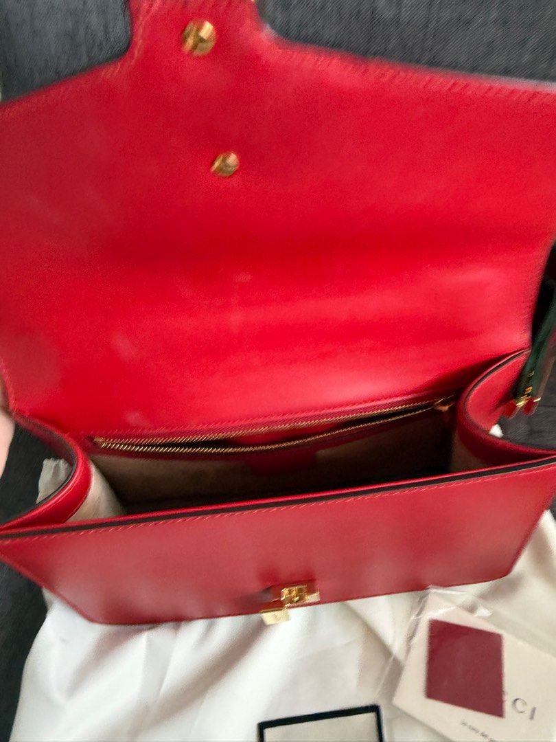 Gucci Sylvie Shoulder Bag (Category: Luxury Bags & Wallets) located in Cebu City. Submitted by kathy.molina (Listing ID 1411389508, Image 3). Description: - Red leather handbag - Gold-tone clasp and hardware - Structured shape with flap closure - Interior zippered pocket - Includes dust bag - Authenticity cards included *** comes wid dustbag, care cards and box ***.