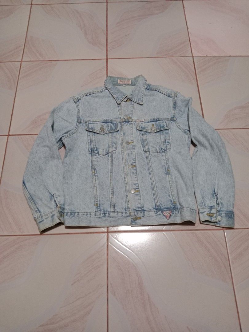 Guess Jeans Acid Wash Denim Jacket (Category: Coats, Jackets and Outerwear) located in Calauan. Submitted by vntg.bless (Listing ID 1411423231, Image 1). Description: - Authentic Guess denim jacket - Acid wash design - Button-up closure - Multiple pockets - Guess logo detail - Made in USA - Size M - Dimes 21.7x25.