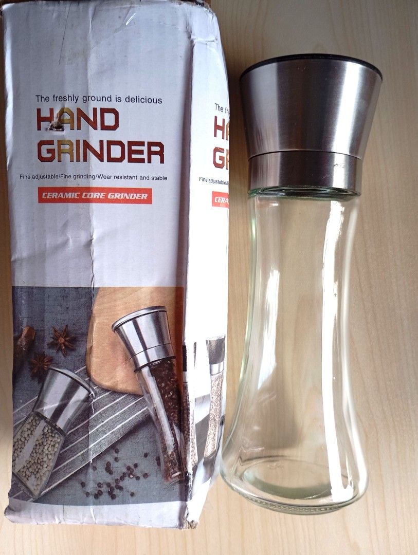 Hand Grinder Ceramic Core (Category: Coffee & Tea Tableware) located in Quezon City. Submitted by ana-chan (Listing ID 1411267078, Image 1). Description: Hand grinder features a ceramic core for efficient grinding. It has a clear glass body and a stainless steel top. The grinder comes with its original packaging. It is designed for grinding spices and herbs. The grinder is easy to use and clean..