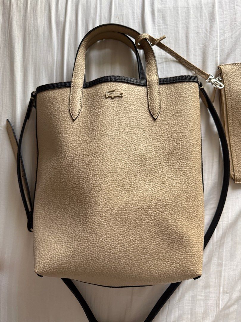 Lacoste Anna Reversible Vertical Tote Bag with detachable pouch (Category: Tote Bags) located in Pasig City. Submitted by abbyrds (Listing ID 1411351663, Image 2). Description: - Reversible Lacoste tote bag - Authentic or money back - Includes a matching beige pouch with zipper closure - Comes with a shoulder strap - Lacoste logo on both bag and pouch RFS: decluttering .