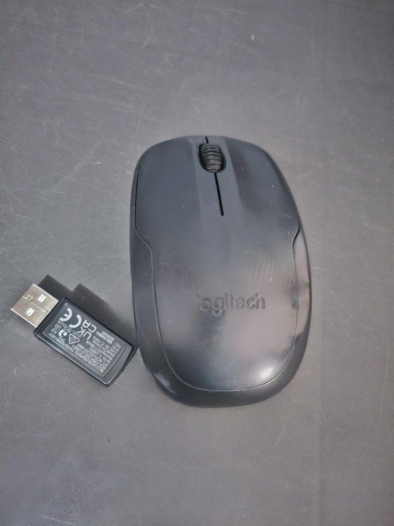 Logitech Wireless Mouse (Category: Mouse & Mousepads) located in Angeles City. Submitted by buxom.cheeks (Listing ID 1411379661, Image 1). Description: - Logitech wireless mouse - Black color - Includes USB receiver - Features a scroll wheel and two buttons - Logitech logo visible.