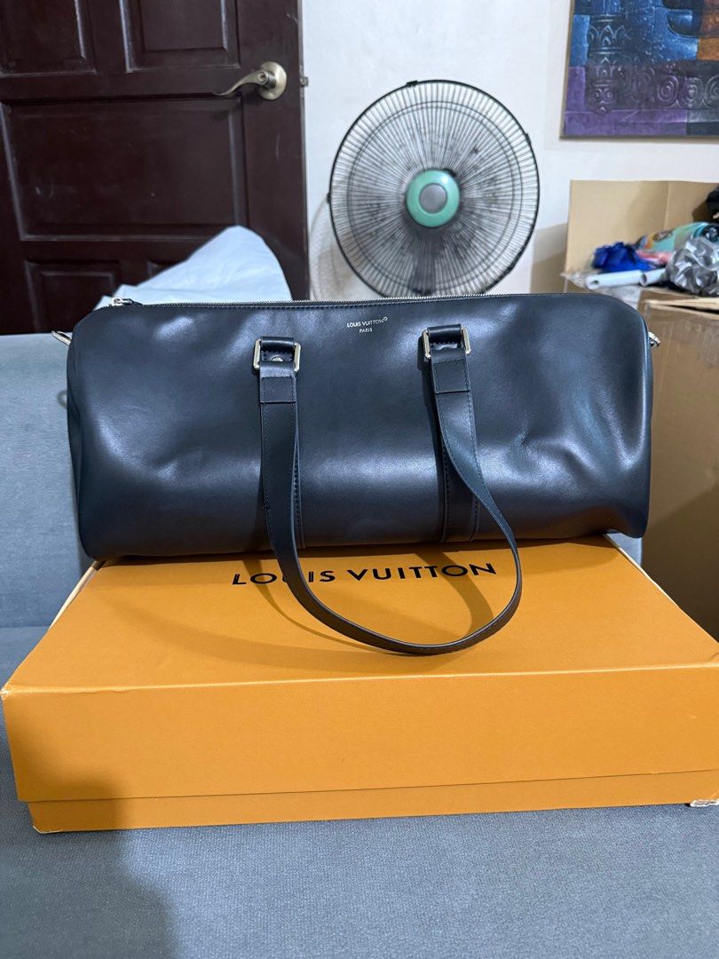 Louis Vuitton Black Leather Duffle Bag (Category: Luxury Bags & Wallets) located in Manila. Submitted by royal.prono (Listing ID 1411410985, Image 1). Description: - Louis Vuitton duffle bag - Black leather - Detachable shoulder strap included - Comes with luggage tag - Original box included - Silver-tone hardware - Includes original receipts and paperwork - Stylish and practical travel bag.