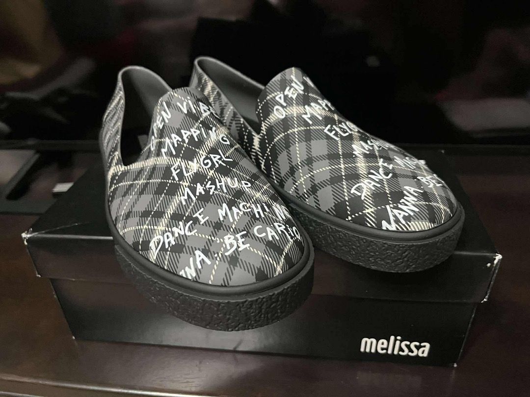 Melissa Plaid Print Slip-On Shoes (Category: Flats & Sandals) located in Paranaque City. Submitted by kerropimarch (Listing ID 1411345367, Image 1). Description: - Stylish Melissa slip-on shoes - Unique plaid pattern with graffiti-style text - Comes with original box - Size: 9 US / 38 BRA / 40 EUR / 25 JPN - Made in Brazil - Unworn, New.