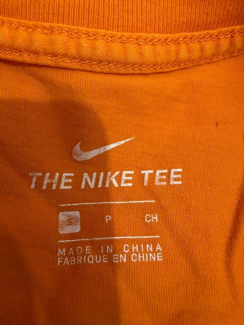 Nike Just Do It Tee - Orange (Category: Tshirts & Polo Shirts ) located in Mandaluyong City. Submitted by getbounced (Listing ID 1411329927, Image 2). Description: Orange Nike t-shirt featuring the iconic "JUST DO IT" slogan. The shirt has a small Nike logo on the front. It is a size S. Made in China. The tag also shows the style code BV7663-873. The shirt's measurements are approximately 25 inches in length and 20 inches in width..