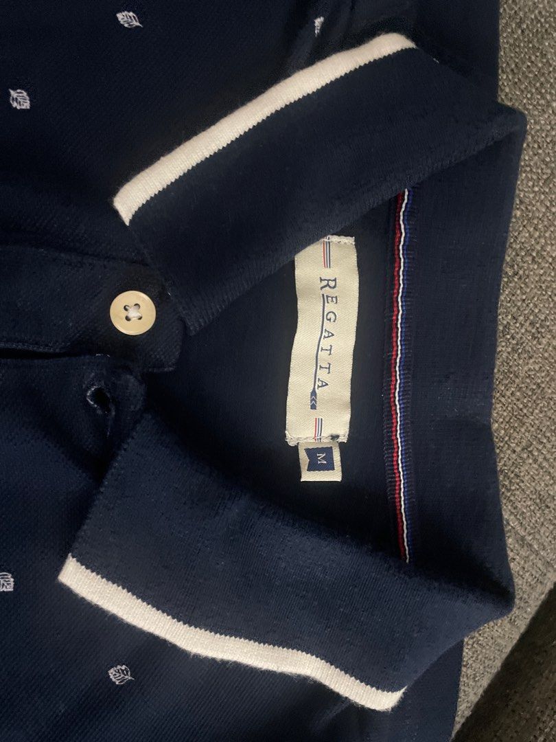 Regatta Navy Blue Polo Shirt - Medium (Category: Tshirts & Polo Shirts ) located in Meycauayan. Submitted by princessbitsandpieces (Listing ID 1411372515, Image 2). Description: - Regatta navy blue polo shirt - Size: Medium - Classic polo collar with white trim - Embroidered logo on chest - White trim on sleeves.