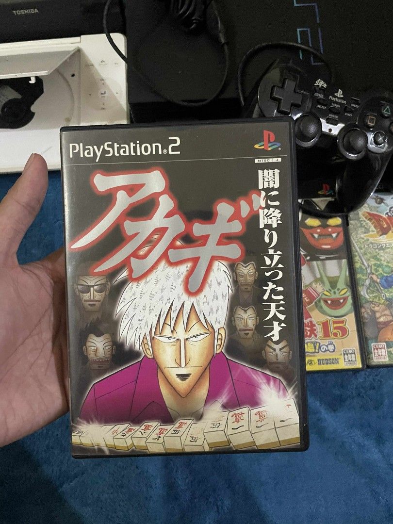 Sony PlayStation 2 Console with Games (Category: PlayStation) located in Manila. Submitted by jaceiz (Listing ID 1411310651, Image 3). Description: Includes a black Sony PlayStation 2 console, two controllers, and several games. Games include titles such as Dragon Quest V and VIII, Dynasty Warriors 4, and more. Also includes a white Toshiba portable DVD player. All items are as shown in the images..
