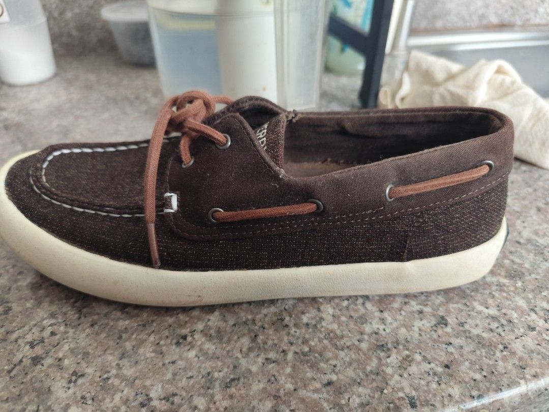 Sperry Top-Sider Brown Boat Shoes (Category: Casual Shoes) located in Manila. Submitted by fcbern (Listing ID 1411331353, Image 3). Description: Brown Sperry Top-Sider boat shoes. Features a brown fabric upper with white stitching and a white sole. The Sperry logo is visible on the heel and insole. Includes brown laces. The shoes have a classic boat shoe design, suitable for casual wear..