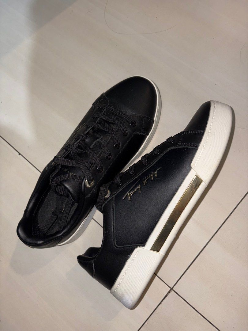 Tommy Hilfiger Black Sneakers (Category: Sneakers) located in Pasig City. Submitted by grumpycat15 (Listing ID 1411387069, Image 3). Description: - Black Tommy Hilfiger sneakers - Black upper - White soles - Tommy Hilfiger logo on insoles - Gold accent on the side - Star pattern on soles - Black laces.