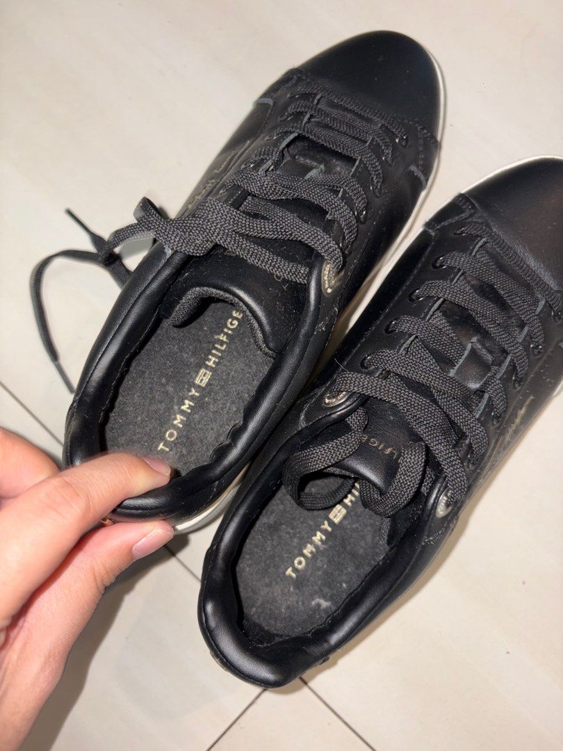 Tommy Hilfiger Black Sneakers (Category: Sneakers) located in Pasig City. Submitted by grumpycat15 (Listing ID 1411387069, Image 2). Description: - Black Tommy Hilfiger sneakers - Black upper - White soles - Tommy Hilfiger logo on insoles - Gold accent on the side - Star pattern on soles - Black laces.