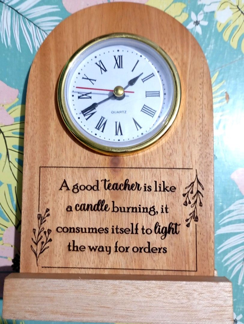 Wood Teachers Clock Gift (Category: Gift Baskets & Hampers) located in Quezon City. Submitted by an.marie (Listing ID 1411272186, Image 1). Description: - Wooden teacher's clock. - Features a classic design with Roman numerals. - Includes an inspirational quote. - Made of wood. - Brandnew .