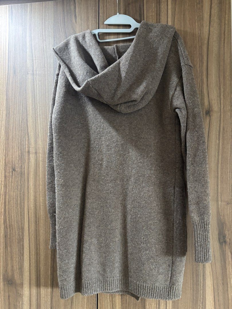 Wool outerwear (Category: Coats, Jackets and Outerwear) located in Singapore. Submitted by taurus15 (Listing ID 1411348113, Image 2). Description: Bought this in Korea during an Autumn trip. Very warm. Free size. Comes with a hood. One hidden button at the front and 2 front pockets. My height is 157cm and this coat is at my knee length. .