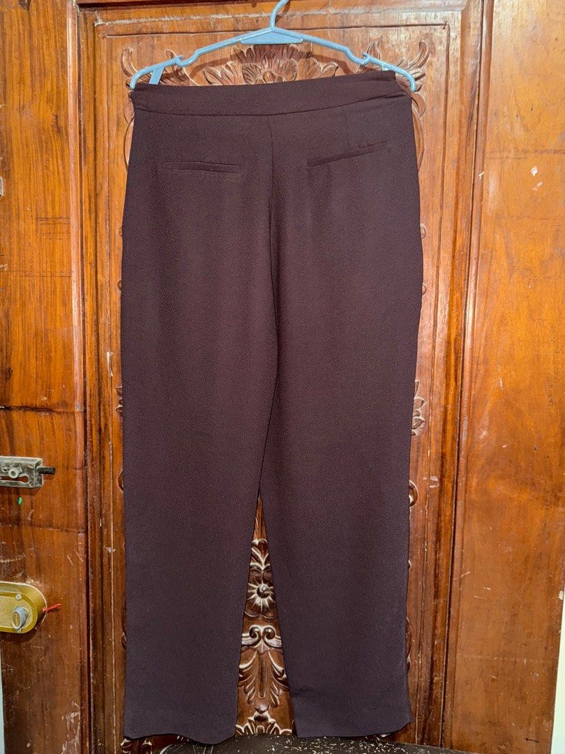 Zara Brown Trousers (Category: Other Bottoms) located in Palayan City. Submitted by decluttering_2018 (Listing ID 1411270939, Image 2). Description: - Zara brown wrap trousers - Unique wrap-style design with hook closure - Tailored fit - Features pockets - Made from a polyester blend - Suitable for casual and semi-formal occasions.