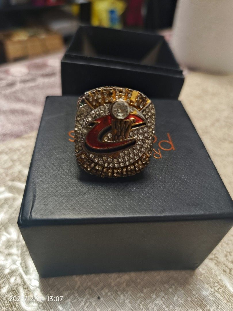 2016 Cleveland Cavaliers Championship Ring (Category: Rings) located in Baguio. Submitted by 01blaze (Listing ID 1411488524, Image 1). Description: Ring commemorates the 2016 Cleveland Cavaliers championship. It features the team logo and the year "2016" on the ring. The ring is presented in a black box. The ring has a gold and silver color scheme with multiple stones..