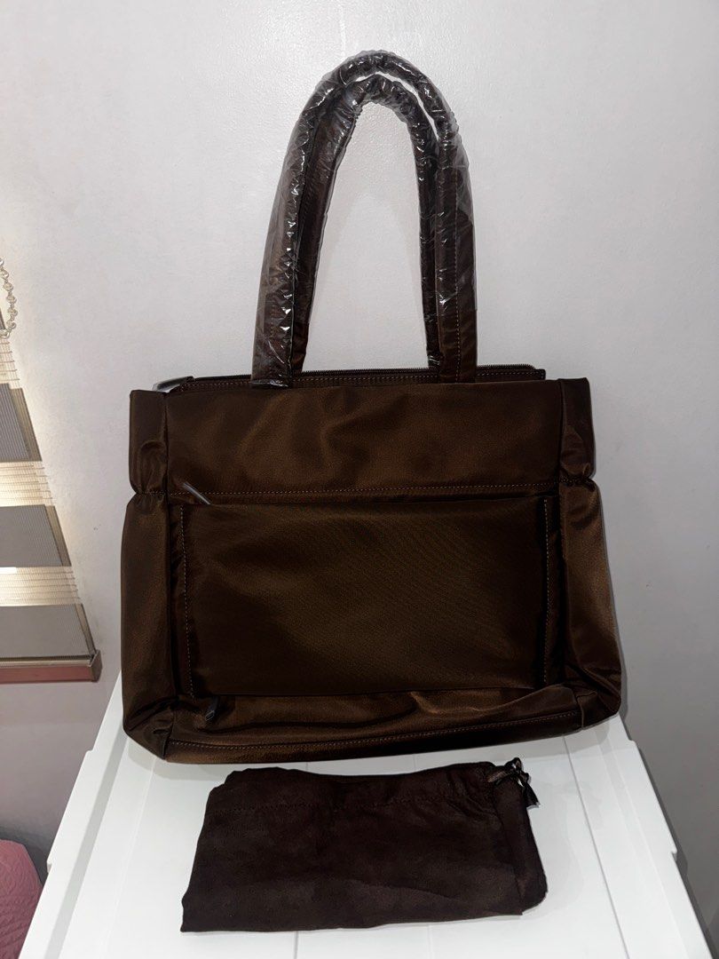 Bash Weekday Tote in Terra (Category: Tote Bags) located in Manila. Submitted by decluterrrr (Listing ID 1411489762, Image 2). Description: - Brand new, rfs is received two of it as a gift - Rich brown color - Spacious interior with multiple compartments - Complete inclusions including dust bag, tag, paper bag - Sturdy handles and sleek design - Features a front pocket and top zipper closure - Perfect for work, travel, or everyday use.