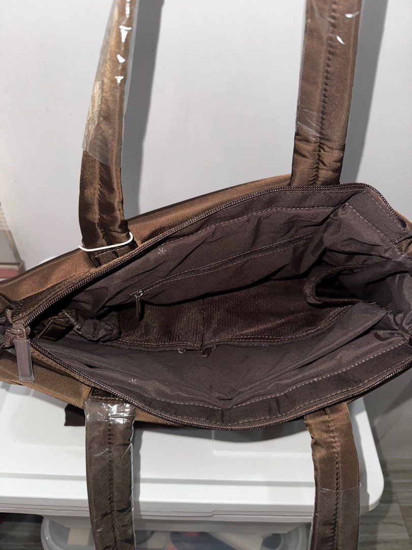 Bash Weekday Tote in Terra (Category: Tote Bags) located in Manila. Submitted by decluterrrr (Listing ID 1411489762, Image 3). Description: - Brand new, rfs is received two of it as a gift - Rich brown color - Spacious interior with multiple compartments - Complete inclusions including dust bag, tag, paper bag - Sturdy handles and sleek design - Features a front pocket and top zipper closure - Perfect for work, travel, or everyday use.
